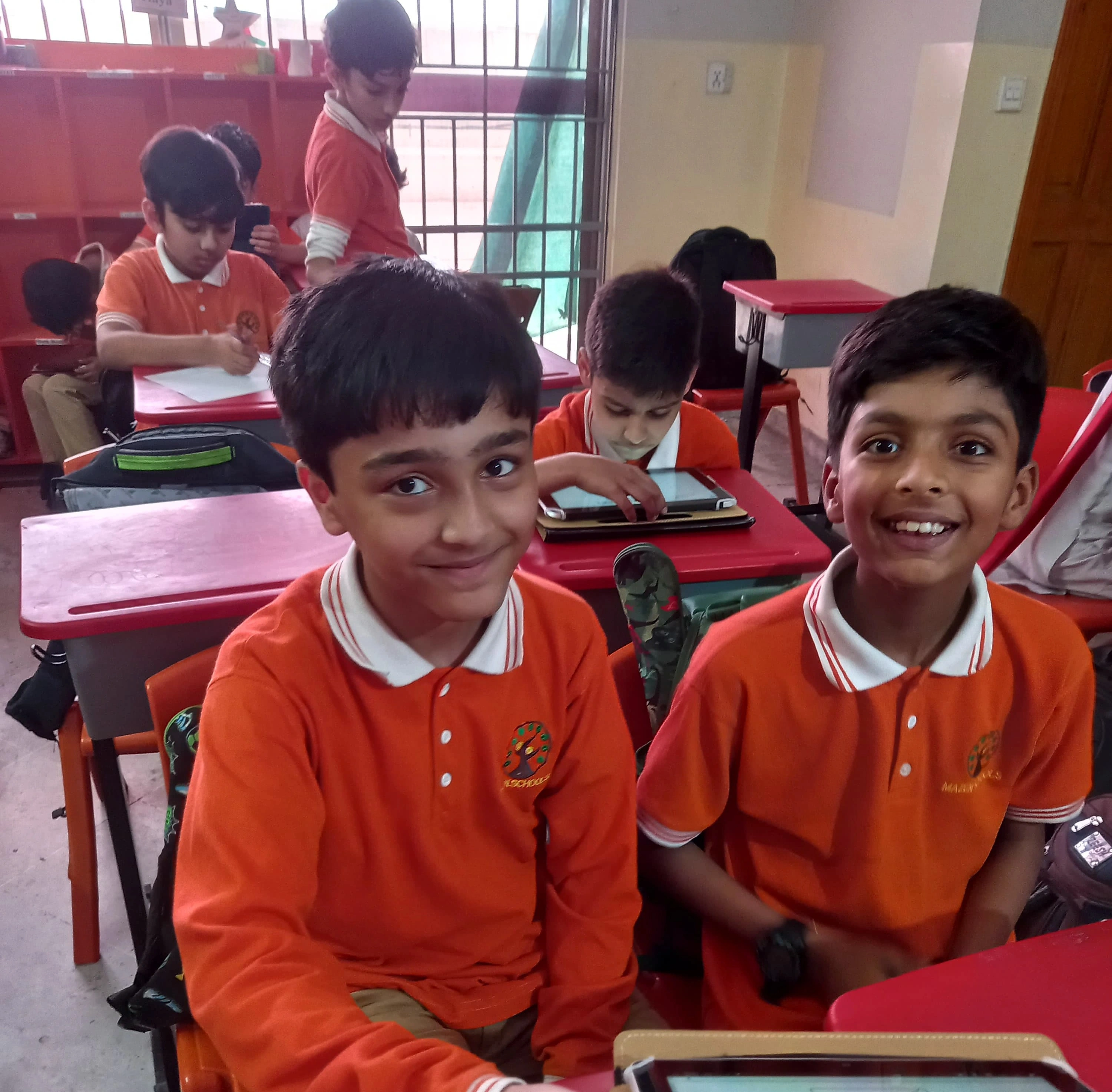 Two children working together on a tablet